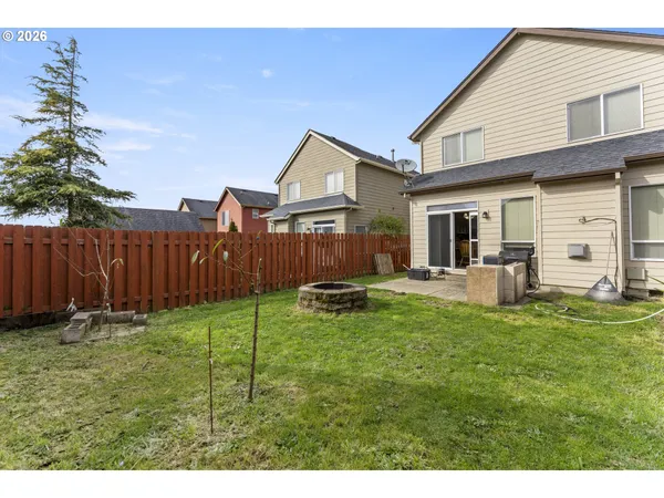 a backyard of a house with table and chairs