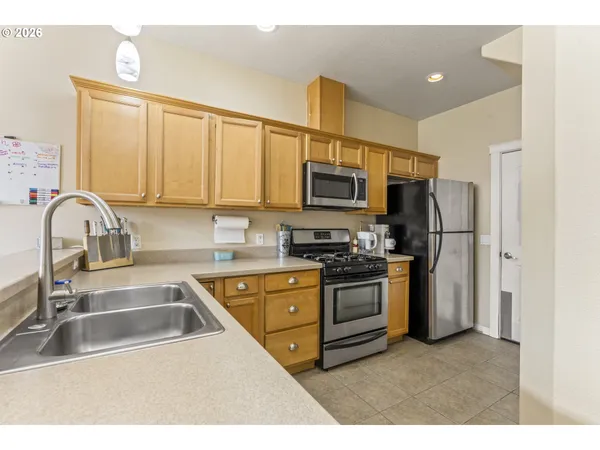a kitchen with a sink stove and refrigerator