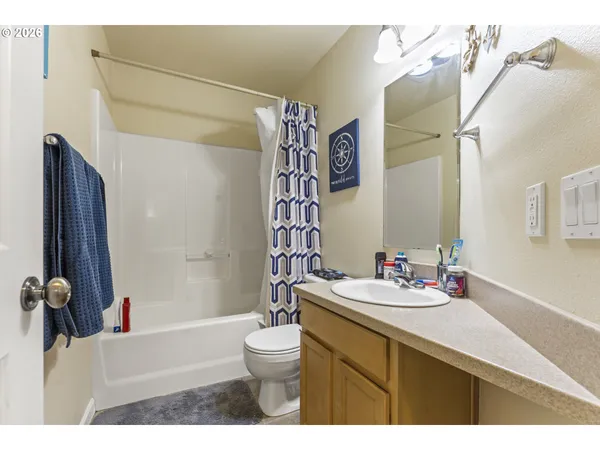 a bathroom with a sink vanity mirror and toilet