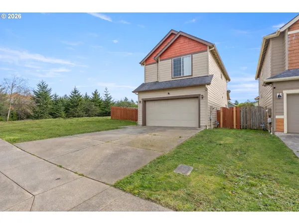 a front view of a house with a yard and garage