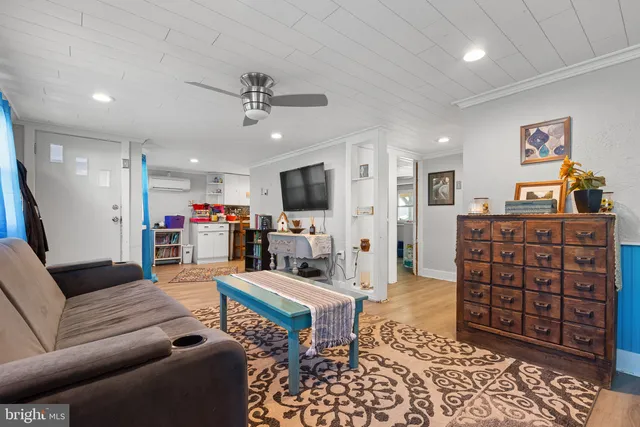 a kitchen area with stainless steel appliances kitchen island granite countertop a table and chairs in it