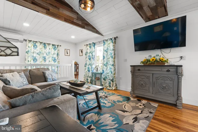 a bedroom with furniture and a wooden floor