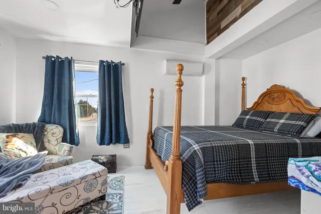 a bedroom with a bed and a window