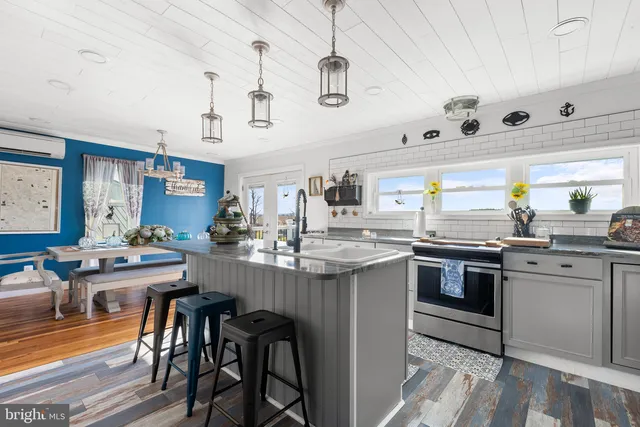 a kitchen with stainless steel appliances granite countertop a refrigerator and a sink