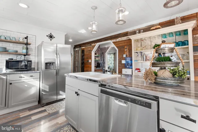 a kitchen with a sink stainless steel appliances and cabinets