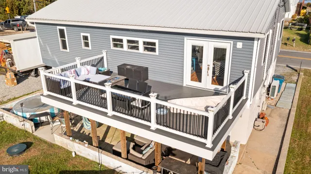 a view of a house with a wooden deck