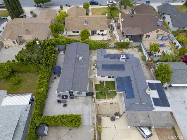 an aerial view of residential houses with outdoor space and street view