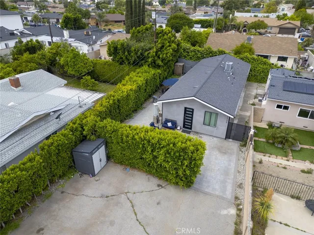 an aerial view of a house with a yard