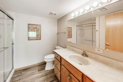 a bathroom with a sink toilet and shower