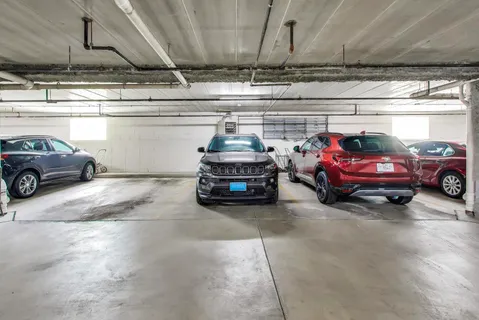 a view of parking garage with cars