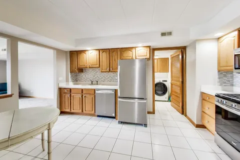 a kitchen with a refrigerator a stove top oven a sink and dishwasher