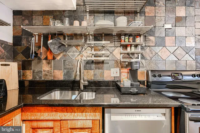 a view of a livingroom with furniture a flat screen tv and staircase