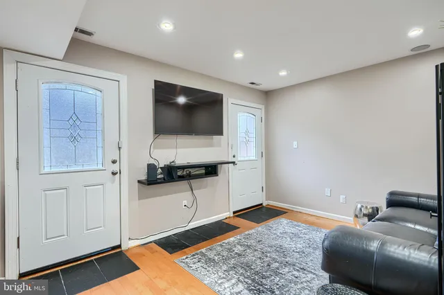 a living room with furniture and stairs
