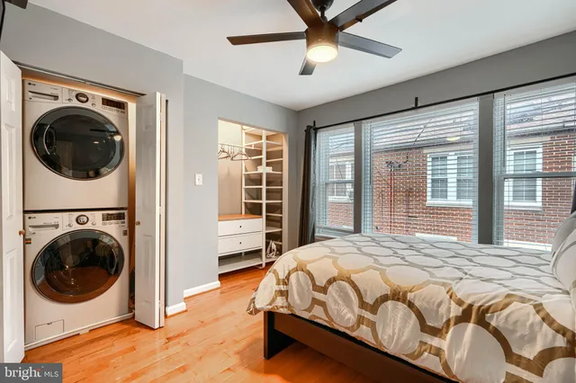 a bedroom with a bed window and a desk