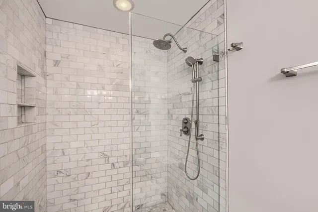 a bathroom with a granite countertop sink a mirror and a potted plant