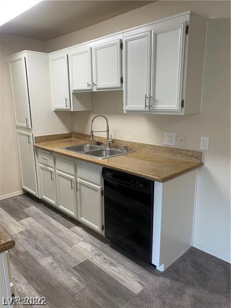 3318 North Decatur Boulevard, Unit 2093 Las Vegas, NV 89130 - Photo 6 of 10 White cabinetry with ample storage and a double sink anchor this functional kitchen space.
