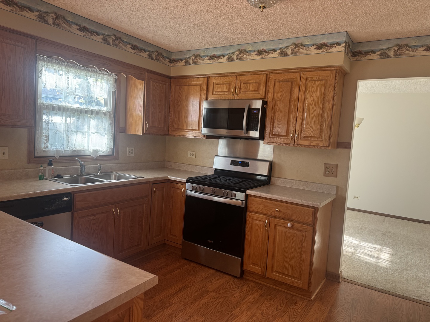 1840 Fairoak Road Naperville, IL 60565 - Photo 4 of 10 a kitchen with stainless steel appliances granite countertop a stove a sink and a microwave