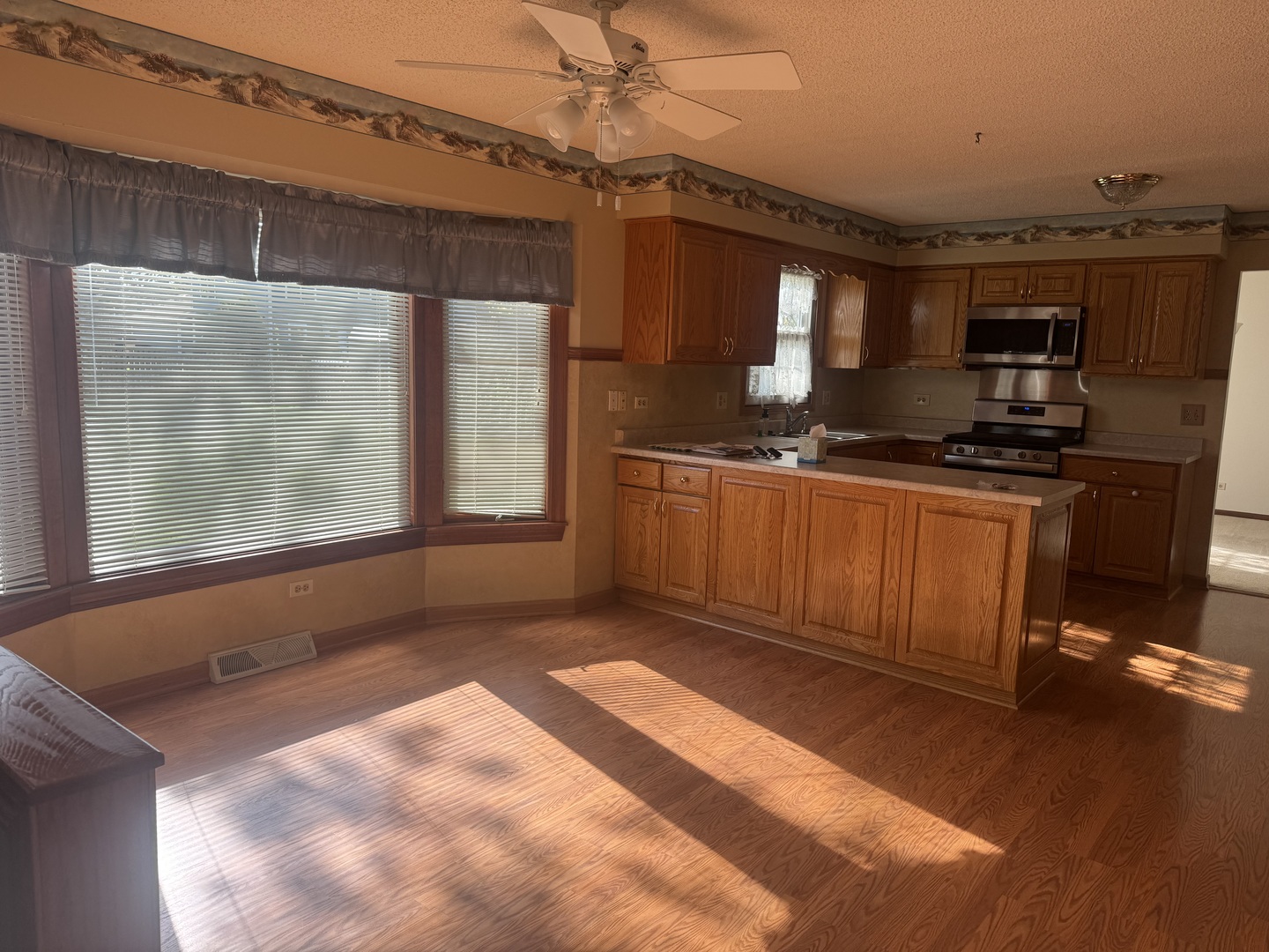1840 Fairoak Road Naperville, IL 60565 - Photo 5 of 10 a kitchen with stainless steel appliances granite countertop a sink stove and refrigerator