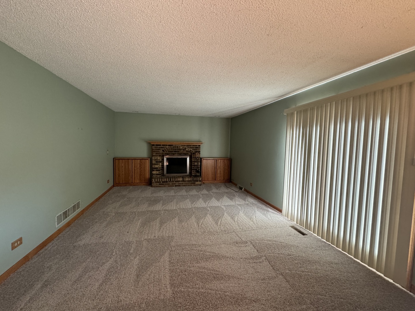 1840 Fairoak Road Naperville, IL 60565 - Photo 6 of 10 an empty room with a fireplace and a window