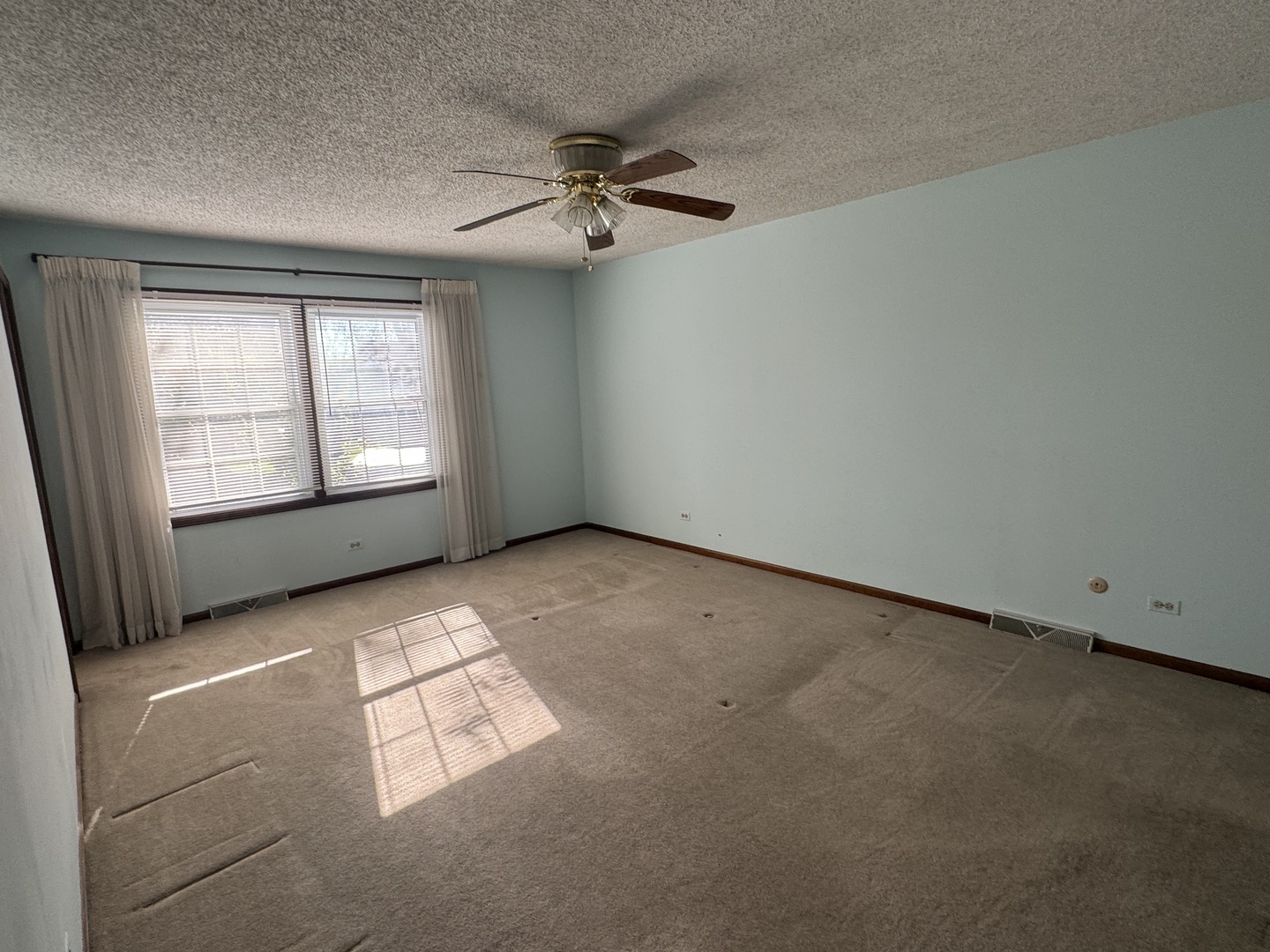 1840 Fairoak Road Naperville, IL 60565 - Photo 7 of 10 an empty room with windows and fan