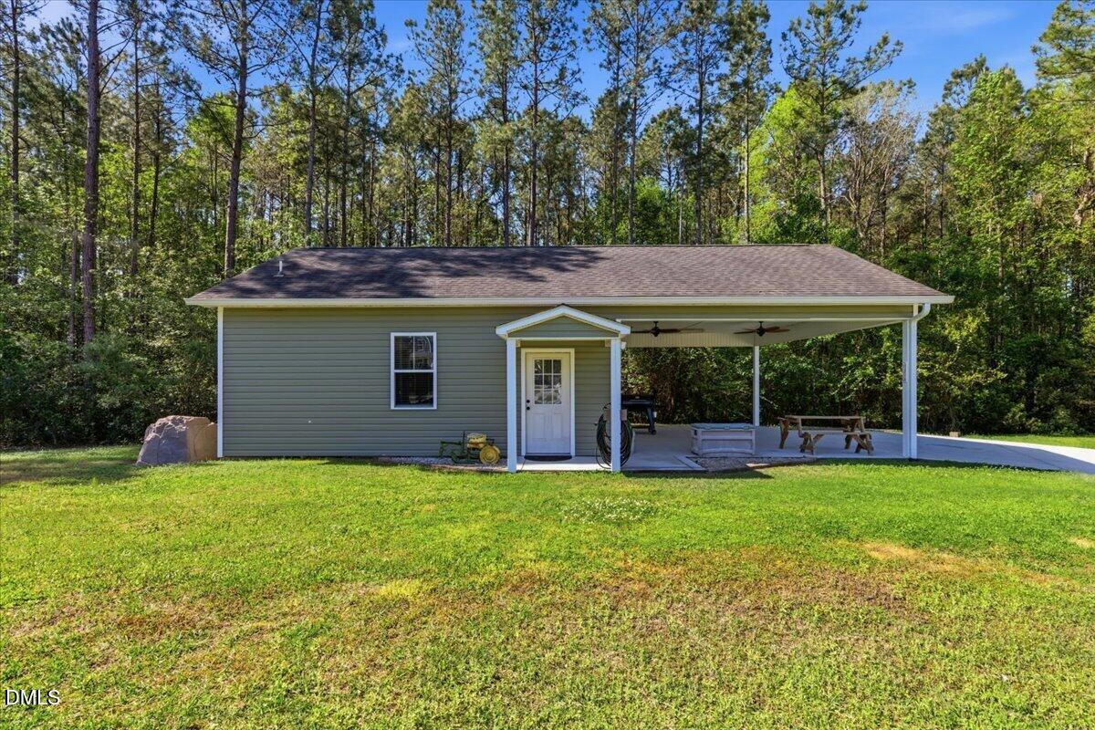 111 West Huckleberry Way Rocky Point, NC 28457 - Photo 17 of 72 a view of a house with a yard and sitting area