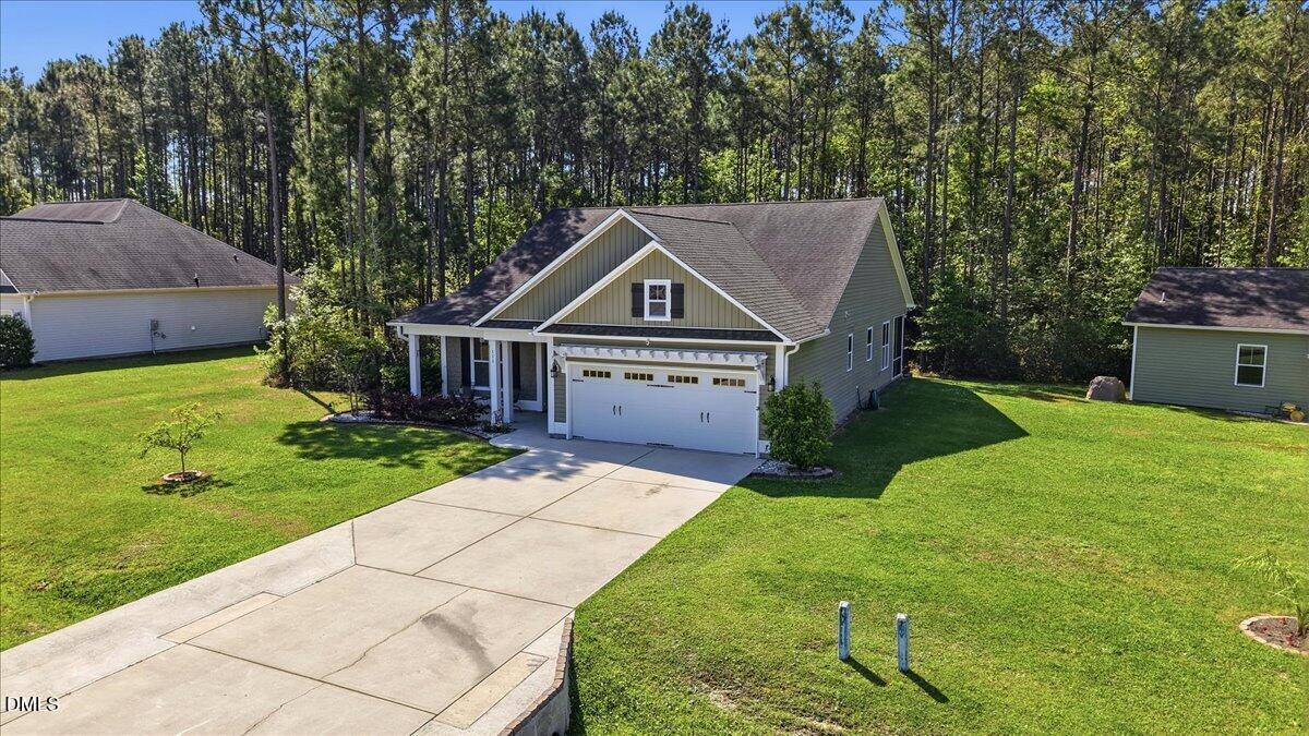 111 West Huckleberry Way Rocky Point, NC 28457 - Photo 25 of 72 a front view of a house with garden