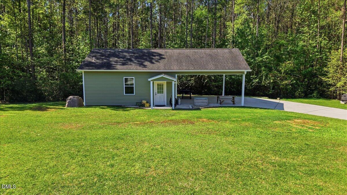 111 West Huckleberry Way Rocky Point, NC 28457 - Photo 26 of 72 a view of a house with backyard and porch