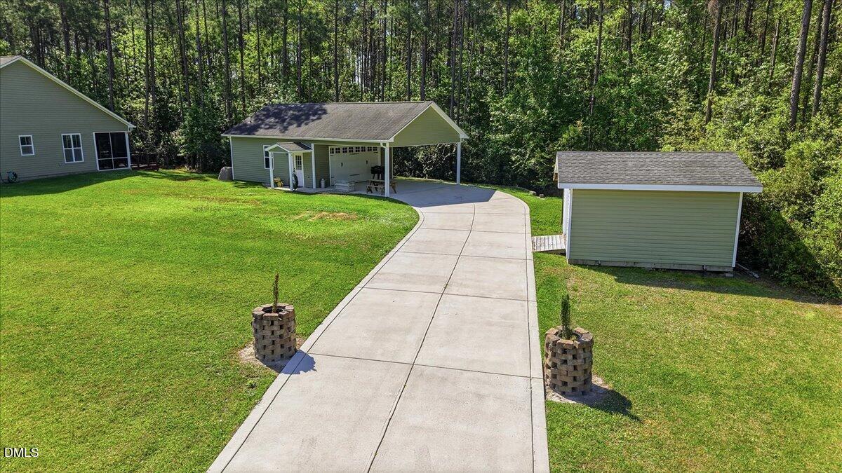 111 West Huckleberry Way Rocky Point, NC 28457 - Photo 28 of 72 a front view of a house with garden