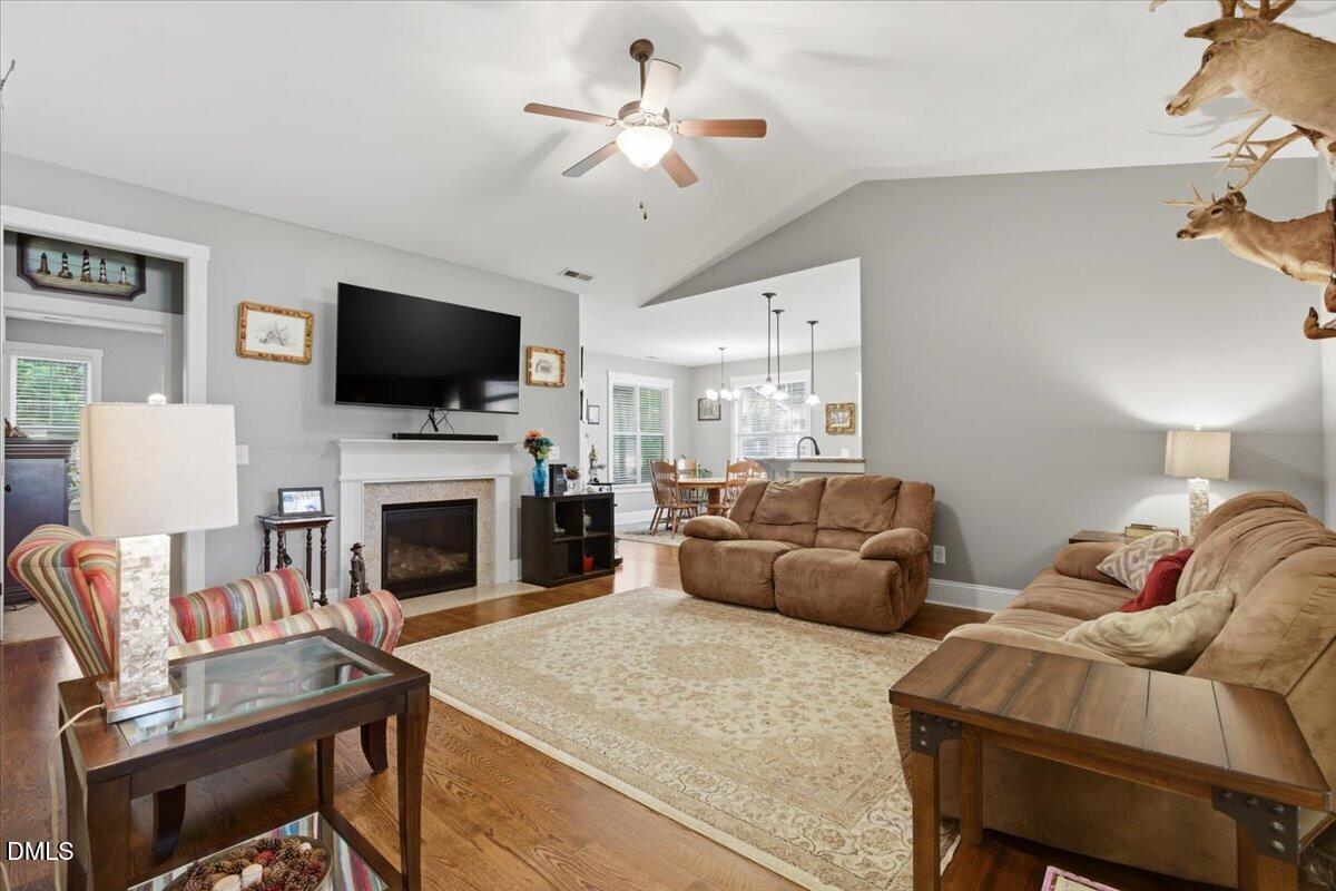 111 West Huckleberry Way Rocky Point, NC 28457 - Photo 30 of 72 a living room with furniture a fireplace and a flat screen tv
