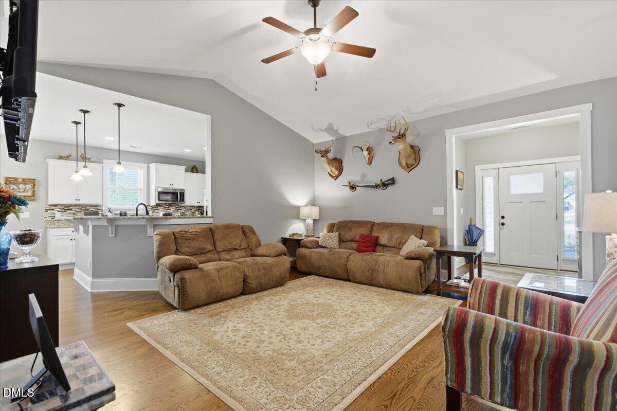 111 West Huckleberry Way Rocky Point, NC 28457 - Photo 31 of 72 a living room with furniture and a chandelier