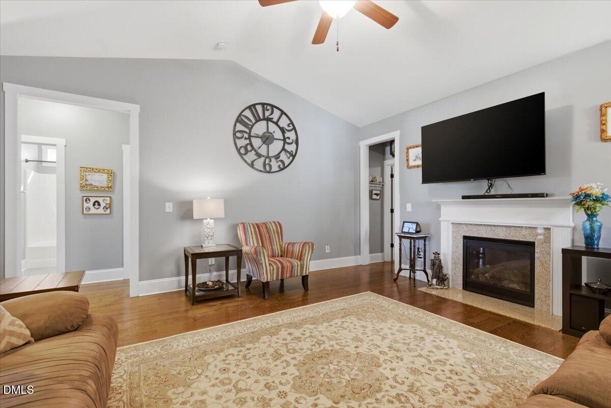 111 West Huckleberry Way Rocky Point, NC 28457 - Photo 35 of 72 a living room with furniture a flat screen tv and a fireplace