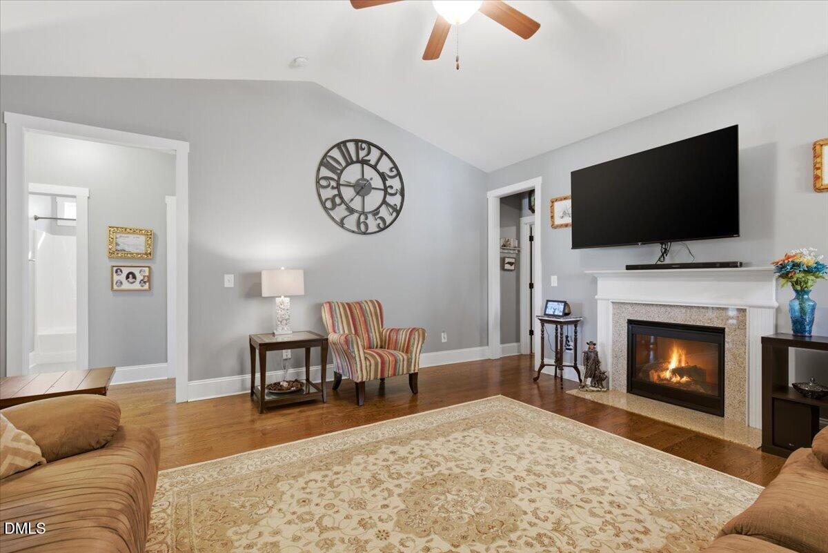 111 West Huckleberry Way Rocky Point, NC 28457 - Photo 36 of 72 a living room with furniture a flat screen tv and a fireplace