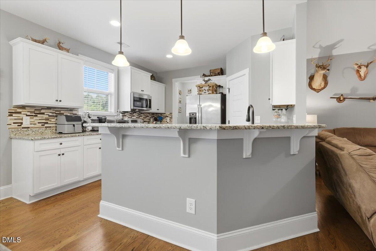 111 West Huckleberry Way Rocky Point, NC 28457 - Photo 38 of 72 a kitchen with stainless steel appliances granite countertop a sink a stove and a refrigerator