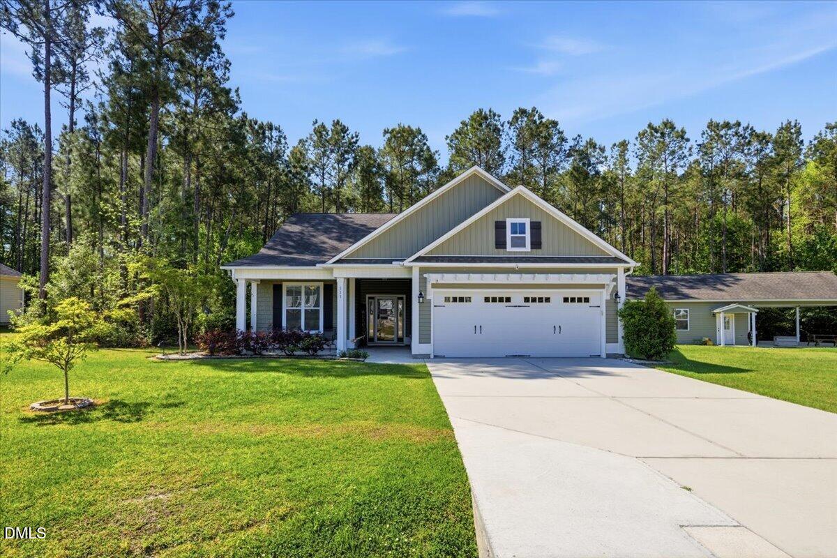111 West Huckleberry Way Rocky Point, NC 28457 - Photo 3 of 72 a front view of a house with a yard