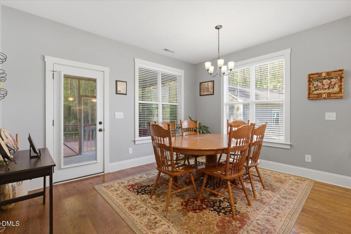 111 West Huckleberry Way Rocky Point, NC 28457 - Photo 43 of 72 a view of a dining room with furniture window and wooden floor