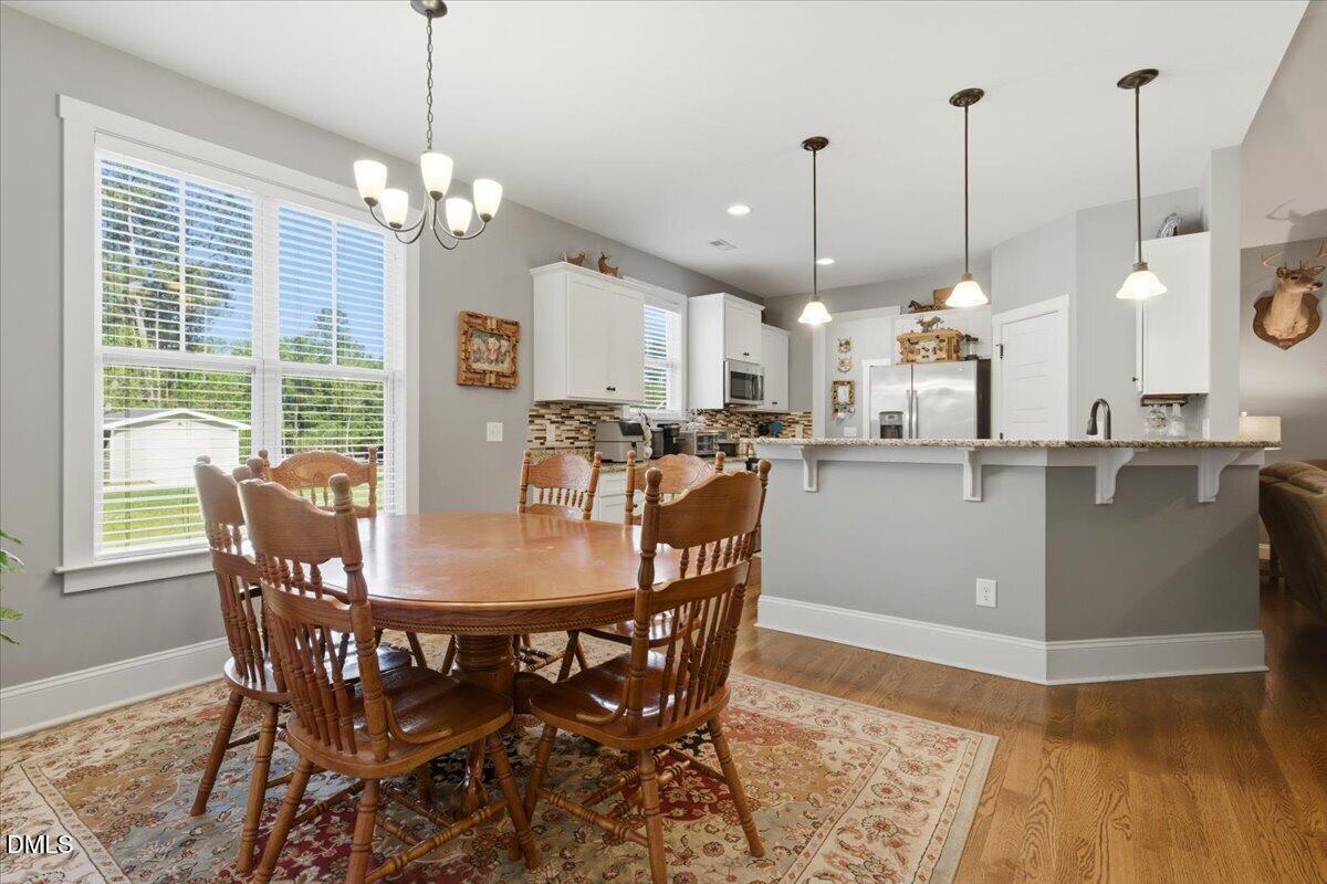 111 West Huckleberry Way Rocky Point, NC 28457 - Photo 44 of 72 a view of a dining room with furniture window and wooden floor