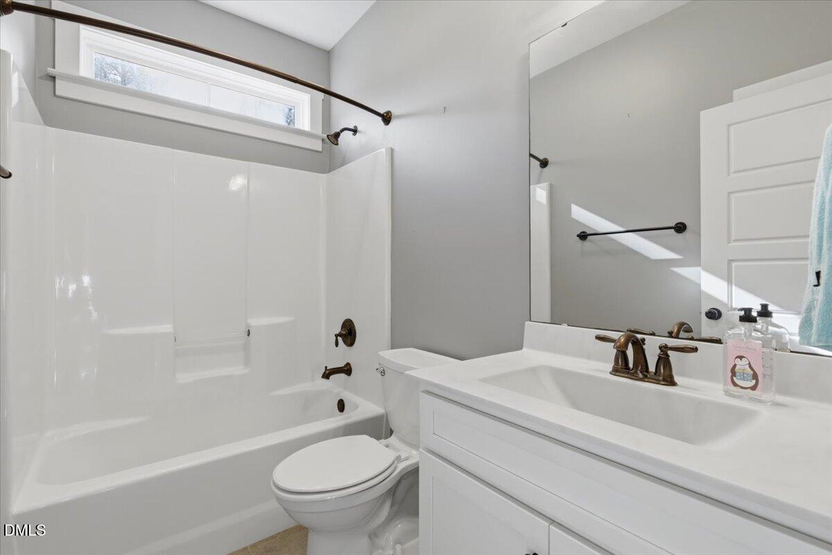 111 West Huckleberry Way Rocky Point, NC 28457 - Photo 48 of 72 a bathroom with a sink a toilet and a mirror