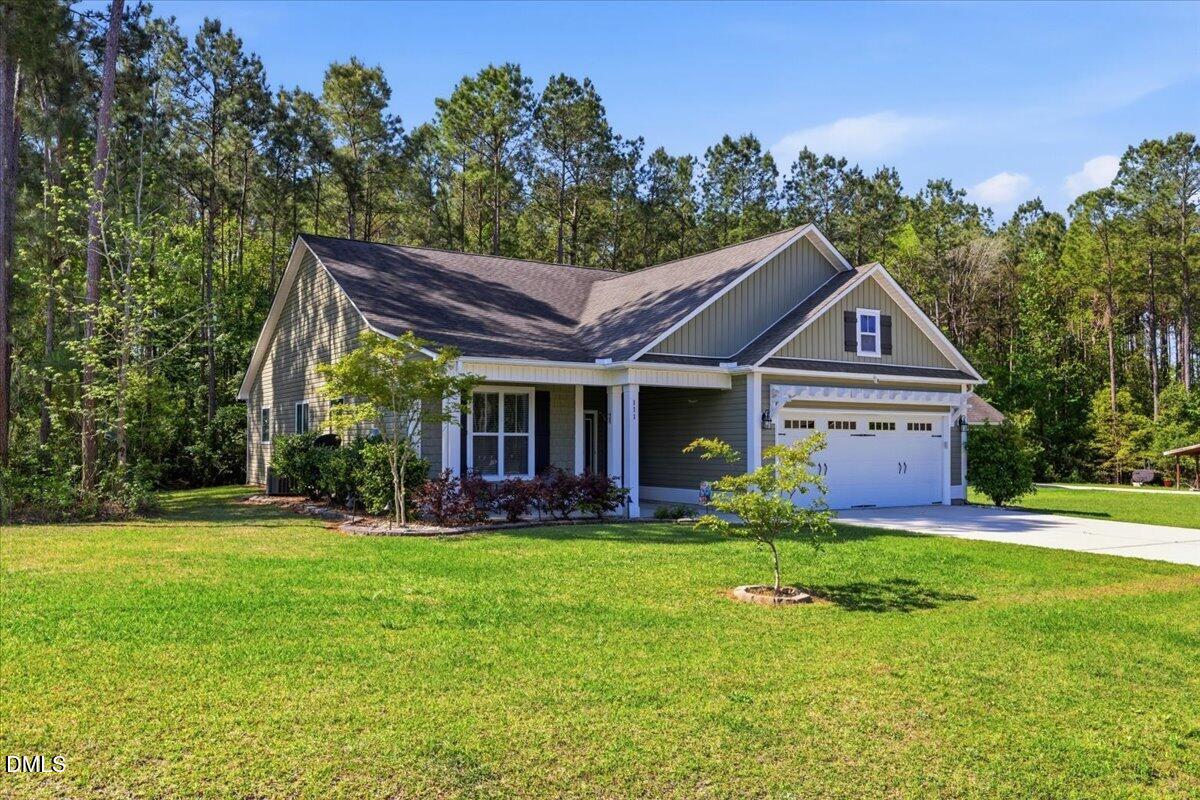 111 West Huckleberry Way Rocky Point, NC 28457 - Photo 4 of 72 a front view of house with yard and green space