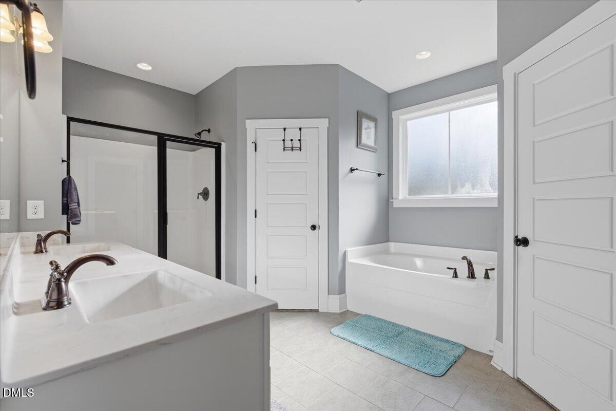 111 West Huckleberry Way Rocky Point, NC 28457 - Photo 53 of 72 a bathroom with a bathtub and a sink