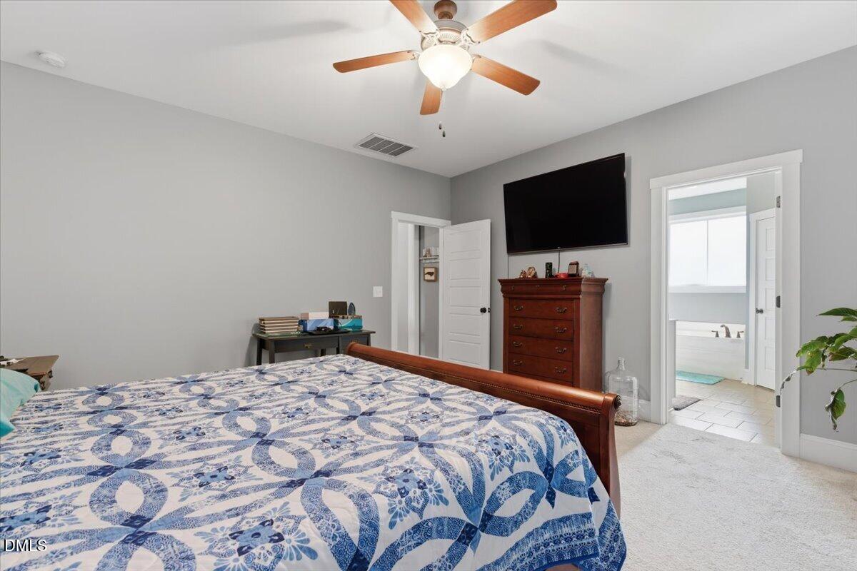 111 West Huckleberry Way Rocky Point, NC 28457 - Photo 54 of 72 a bedroom with a bed and a flat screen tv