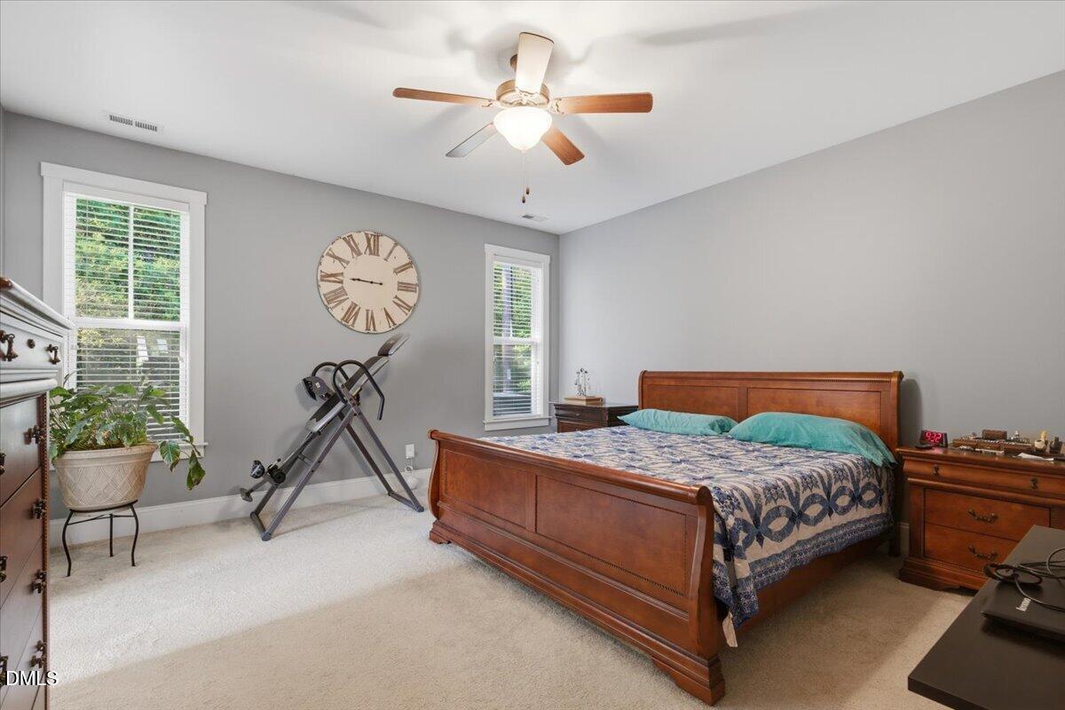 111 West Huckleberry Way Rocky Point, NC 28457 - Photo 55 of 72 a bedroom with a bed and a chandelier