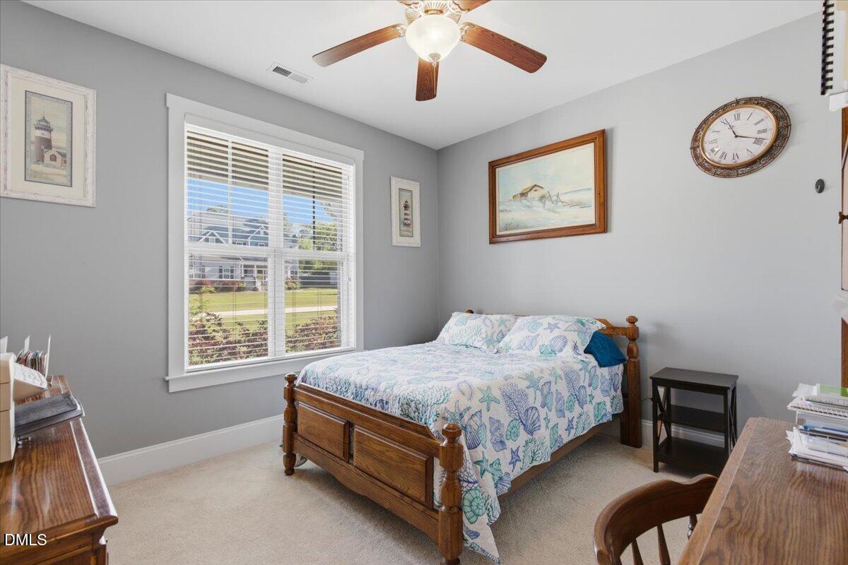 111 West Huckleberry Way Rocky Point, NC 28457 - Photo 57 of 72 a bed room with a bed and a chair