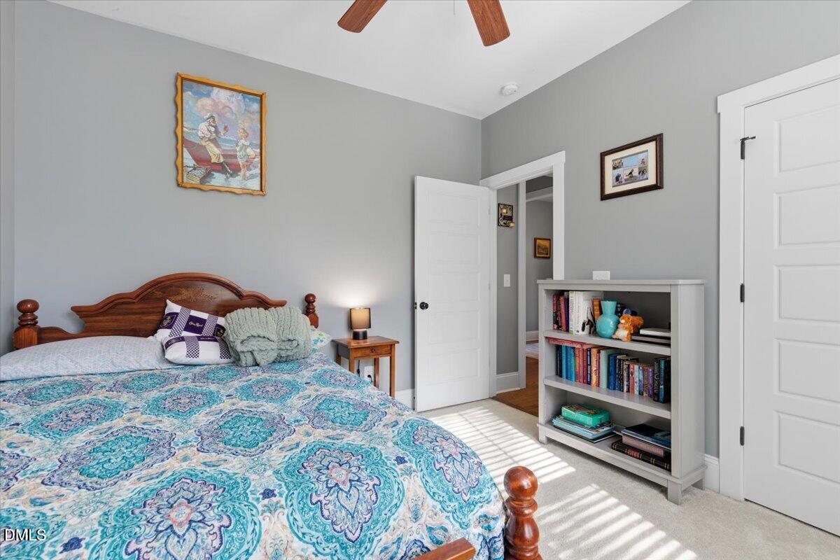 111 West Huckleberry Way Rocky Point, NC 28457 - Photo 58 of 72 a bedroom with a bed and a book shelf