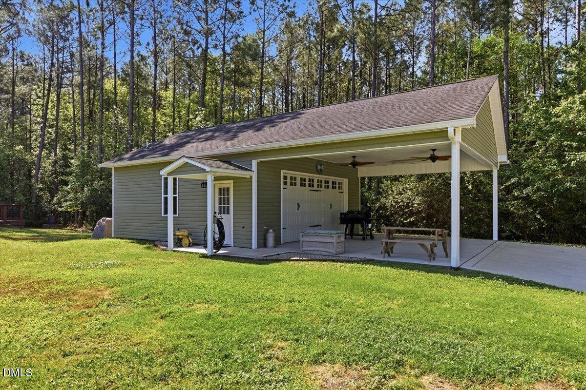 111 West Huckleberry Way Rocky Point, NC 28457 - Photo 5 of 72 a view of a house with a yard and sitting area