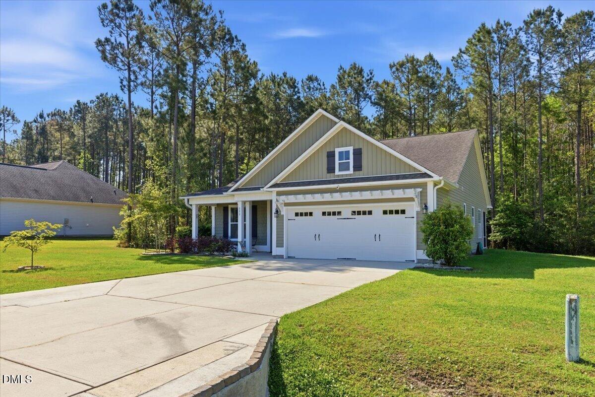 111 West Huckleberry Way Rocky Point, NC 28457 - Photo 65 of 72 a front view of a house with a yard and garage