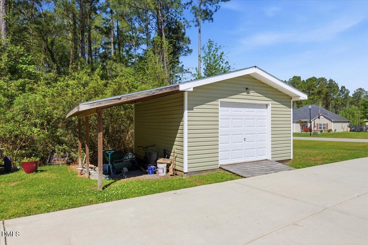 111 West Huckleberry Way Rocky Point, NC 28457 - Photo 66 of 72 a front view of a house with a garden and yard