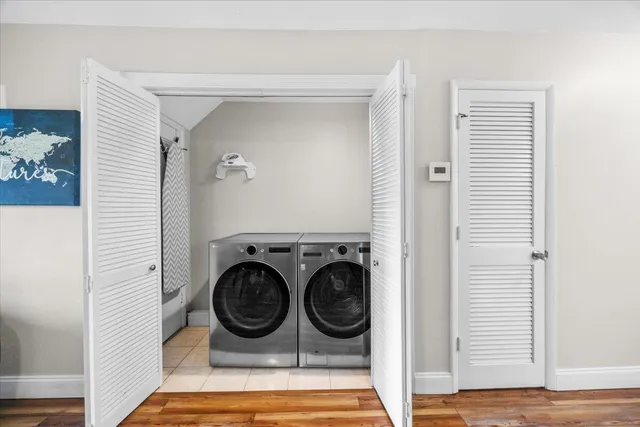 a bedroom with a bed and a flat tv screen on dresser