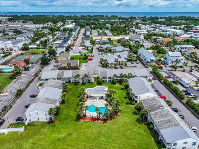 an aerial view of a house with garden space and lake view