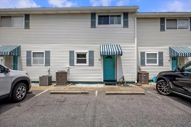 a kitchen with a refrigerator and white cabinets