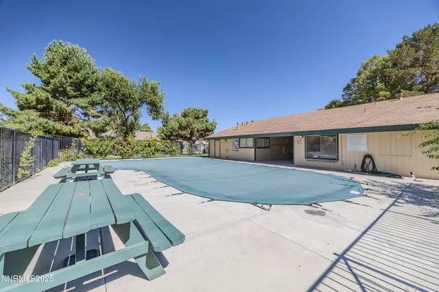a view of a house with backyard and trees